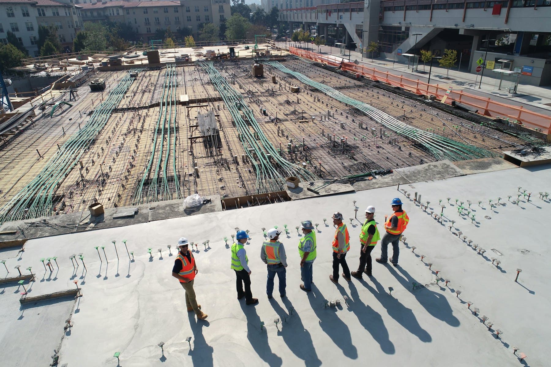 Construction team reviewing a site from a concrete deck