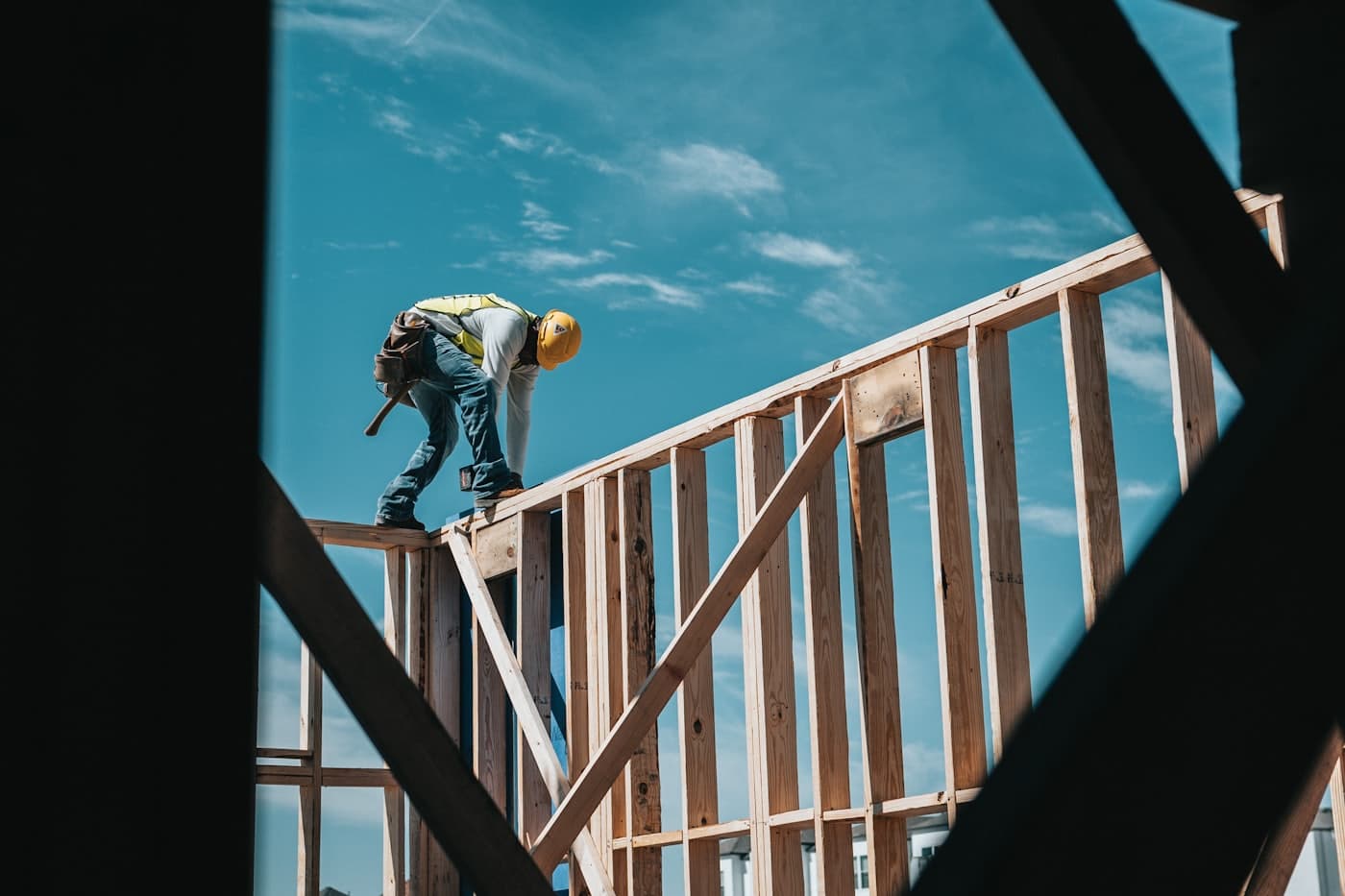 Carpenter framing the timber structure of a new building